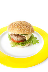 fast food, beef and cheese hamburger on yellow plate.