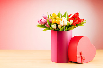 Giftbox and tulips against gradient background