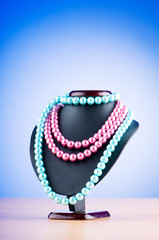 Pearl necklace against gradient background