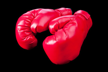 Red boxing gloves isolated on black