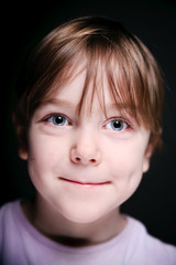 Portrait of a child on a black background.