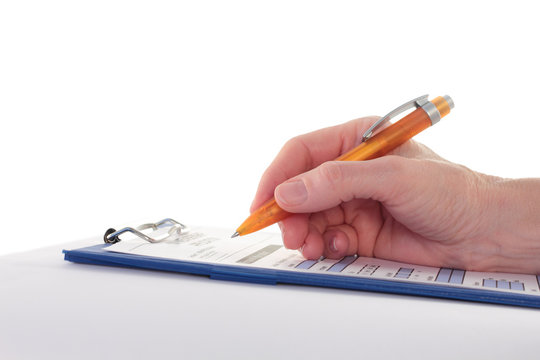 Hand Completing a Form on Clipboard