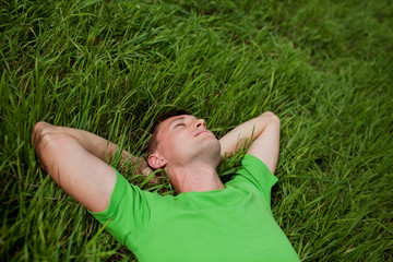 young man lying on the grass