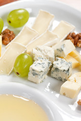 Cheese plate with grapes and honey