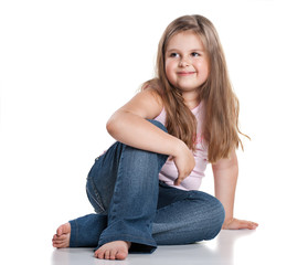 Cute happy little girl sitting on white background