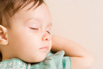 little girl sleeping on sofa