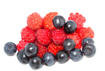 berries of raspberry and bilberry on white background..
