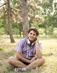 Smiling handsome man with headphones at outdoors