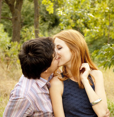 Young couple in love kissing outdoors.