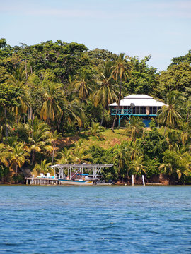 Tropical land at the edge of the Caribbean sea with a dock and an house, Bocas del Toro, Panama, Central America