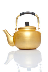 Old gold teapot isolated on the white background
