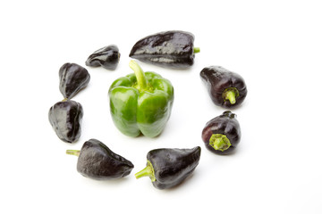 Green pepper in the ring of black pepper