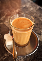 Cup of Chai tea with sugar cubes