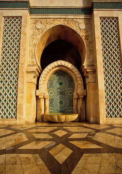 Ornate fountain and geometric patterns outside of a mosque
