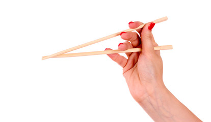 woman's hand and wooden chopsticks isolated on white