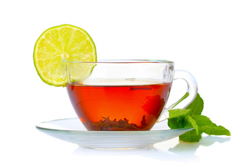 black tea in cup, mint and lime isolated on white