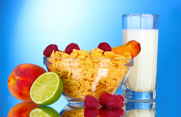 tasty cornflakes, fruit in glass bowl and milk