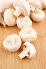 Fresh mushrooms champignon on wooden background