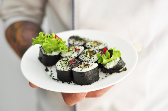 Sushi chef holding Sushi Plate