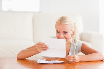 Happy woman reading a letter