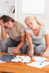 Fototapeta premium Despaired stressed couple calculating their expenses