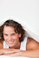 Portrait of a man under a duvet