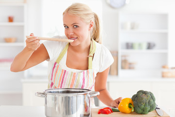 Blonde woman tasting her meal