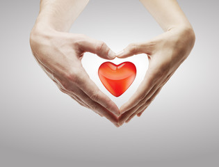 Fototapeta premium Heart shape made of female and male hands together