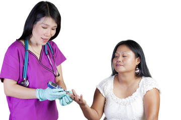 Asian nurse checking glucose