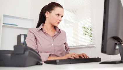 Businesswoman typing on keyboard