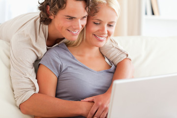 Fototapeta premium Lovely young couple using a laptop