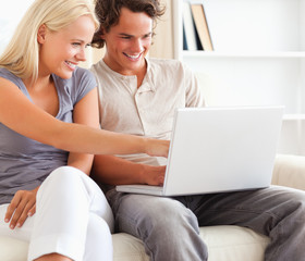 Fototapeta premium Close up of a couple using a laptop