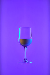 Goblet with white wine on blue