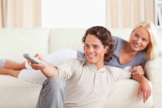 Smiling young couple watching TV