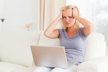 Unhappy woman holding a laptop