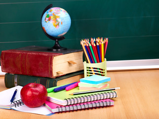 Books and blackboard. School supplies.