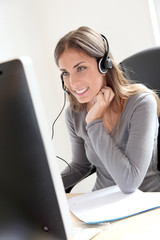Portrait of beautiful office worker sitting at her desk