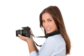 Portrait of woman using reflex digital camera