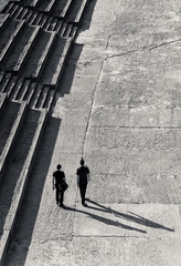 Two adults walking together with shadow