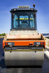 compactor at asphalt pavement works (road repairing)