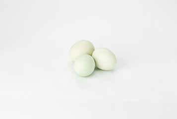Three green eggs on white