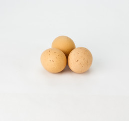 Three spekled brown eggs on white