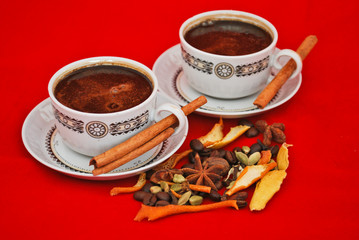 Black coffee and spices isolated on red