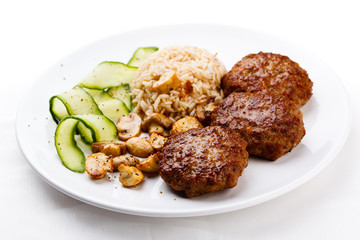 Fried steaks with rice and vegetable salad