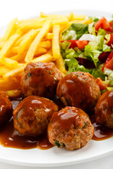 Roasted meatballs, French fries and vegetable salad