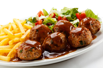 Roasted meatballs, French fries and vegetable salad