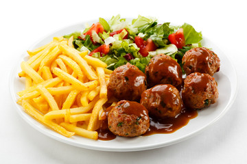 Roasted meatballs, French fries and vegetable salad - obrazy, fototapety, plakaty