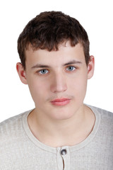 Close-up portrait of teenage boy in knitted light-grey shirt