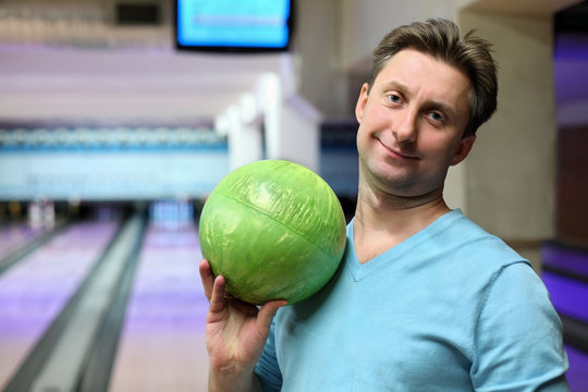 Portrait of man with ball for bowling