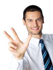 Portrait of businessman showing three fingers, isolated